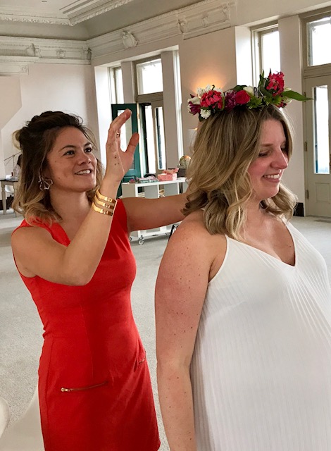 Co-hostess Melissa Frost places a flower crown on Kate. So many special touches!